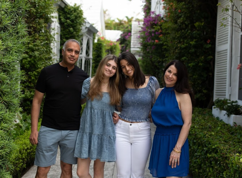 Kareena and family stand in front of greenery together